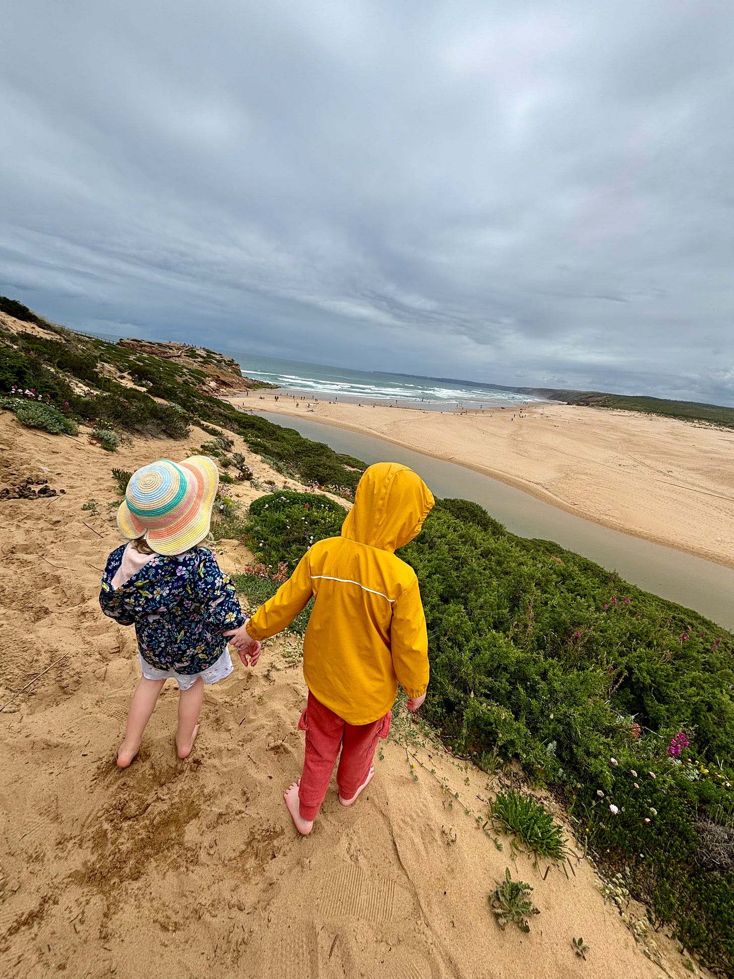 two children at Praia da Bordeira two children at Praia da Bordeira