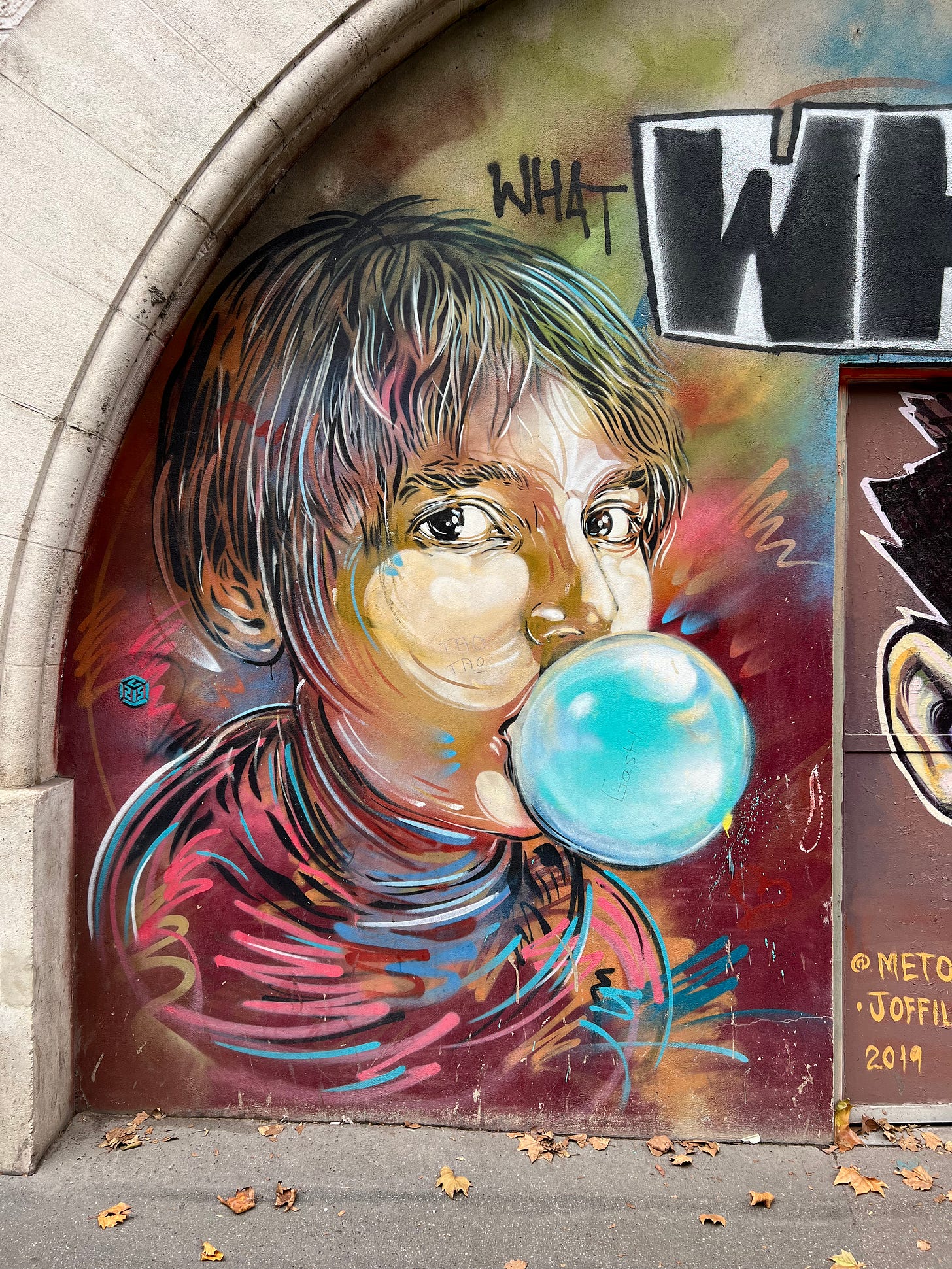 Vivid mural in Paris’s 13th arrondissement showing a young girl blowing a bubble.