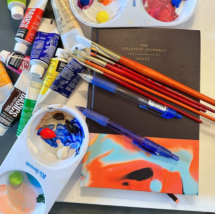 On the left is a photo of the Isolation Journal No. 1 along with pens, paint brushes, a palette, and various tubes of paint; so colorful! On the rihgt is a photograph of a small spotted dog with one brown eye and one blue eye, seated on a char beside the Surrender tote.