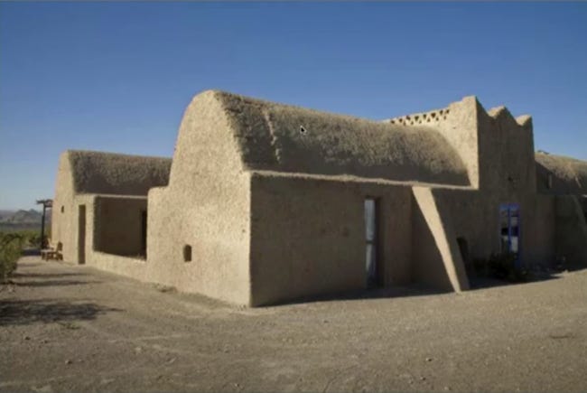 Adobe longhouse with a tall cone-shaped vaulted roof. Adobe longhouse with a tall cone-shaped vaulted roof.