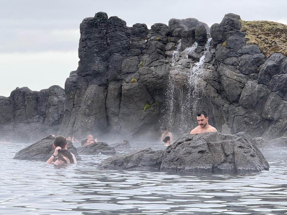 People in the water with a waterfall

AI-generated content may be incorrect.
