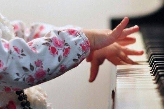 May be an image of baby and piano