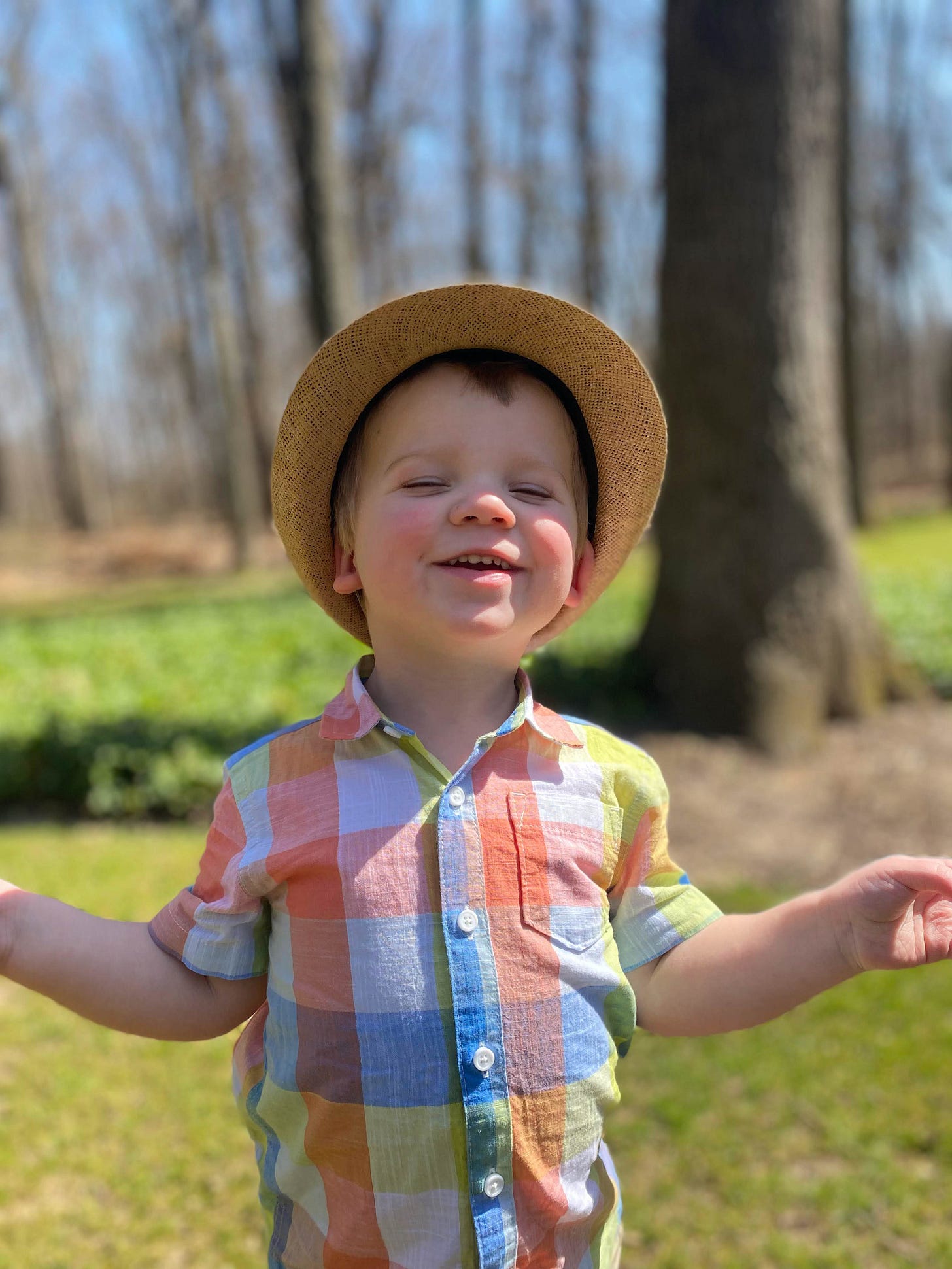 Toddler (author's grandson) smiling with joy wearing his Easter best.