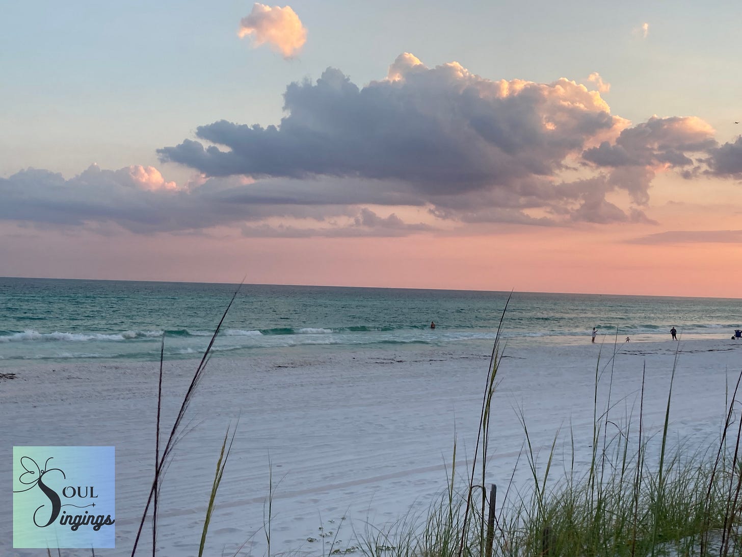 On the Lookout for God:  a pink sunset with clouds over a white sand beach