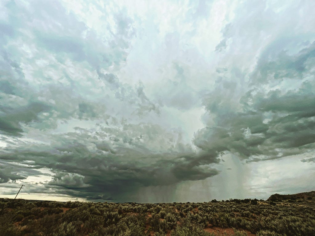 A cloudy sky over a field

Description automatically generated