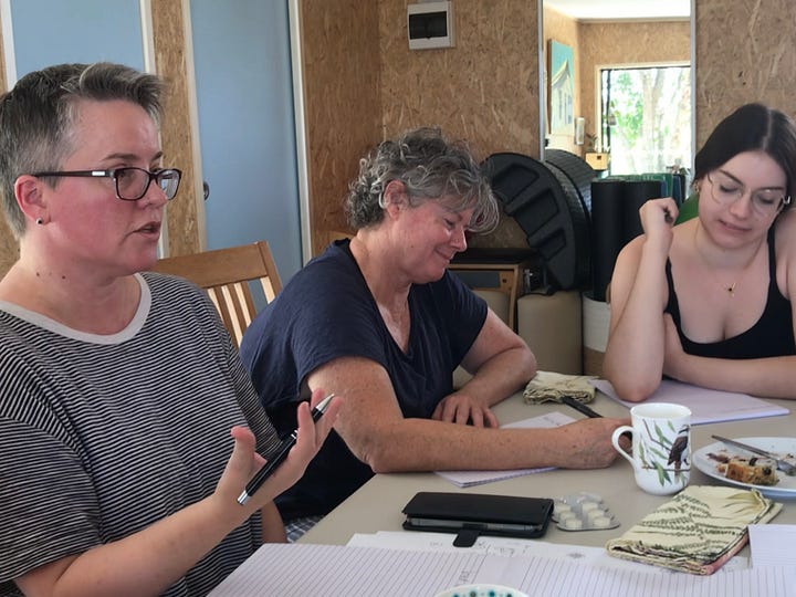 Photo 1: crystal singing bowls sitting on a mat with a set of chimes and metal singing bowls off to the side. Photo 2: three people sitting at a table and writing.