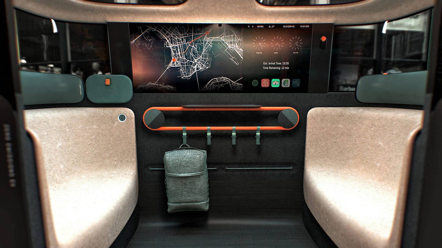 The Dromos autonomous vehicle interior. Two seats are facing one another, a large digital map is shown on the central window, while beneath, coat hooks are against the bottom wall of the vehicle. A rucksack hangs off one of the hooks The Dromos autonomous vehicle interior. Two seats are facing one another, a large digital map is shown on the central window, while beneath, coat hooks are against the bottom wall of the vehicle. A rucksack hangs off one of the hooks