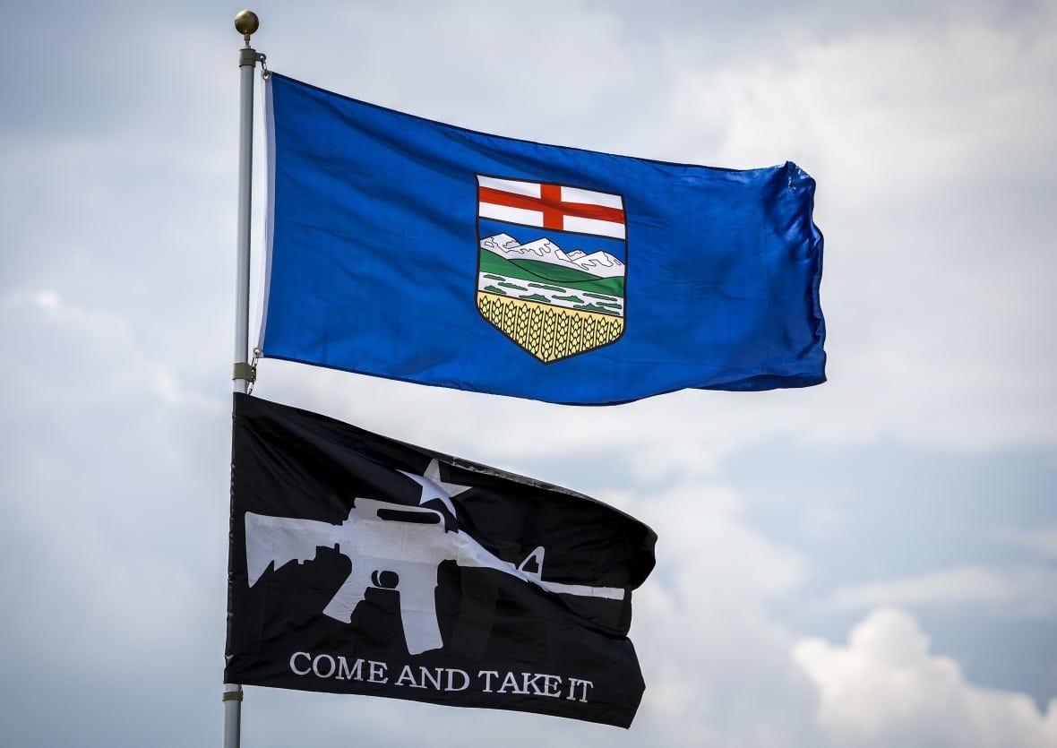 An Alberta flag and a pro-firearms flag are displayed outside a rural residence near Crossfield, Alta., Tuesday, June 13, 2023. An Alberta flag and a pro-firearms flag are displayed outside a rural residence near Crossfield, Alta., Tuesday, June 13, 2023.