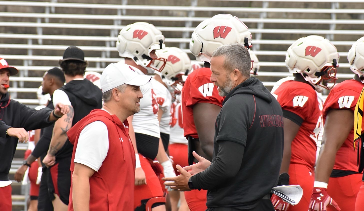 Wisconsin Badgers defensive coordinator Mike Tressel talks with position coach Matt Mitchell during fall camp. Wisconsin Badgers defensive coordinator Mike Tressel talks with position coach Matt Mitchell during fall camp.