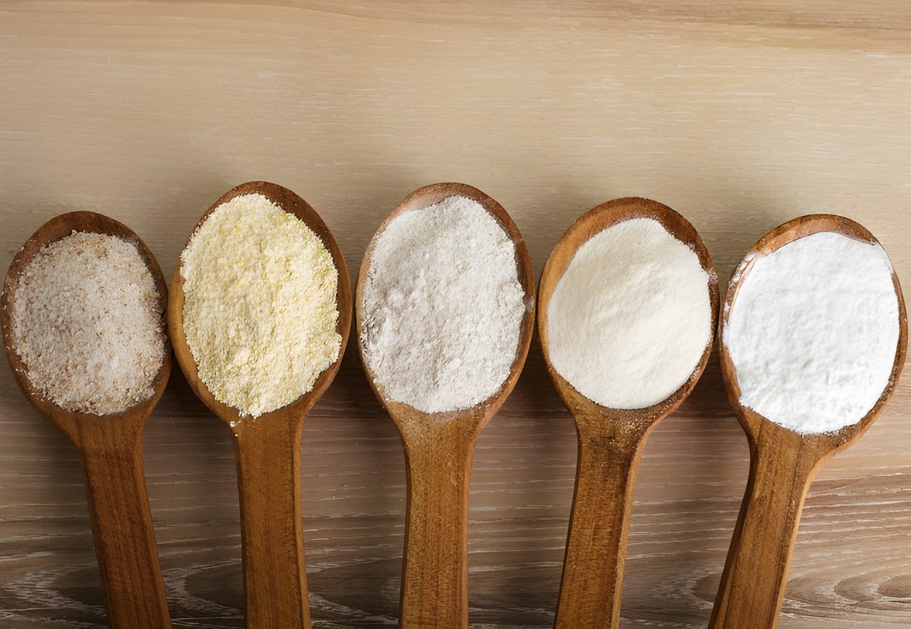 5 alternative flours lined up on wooden spoons