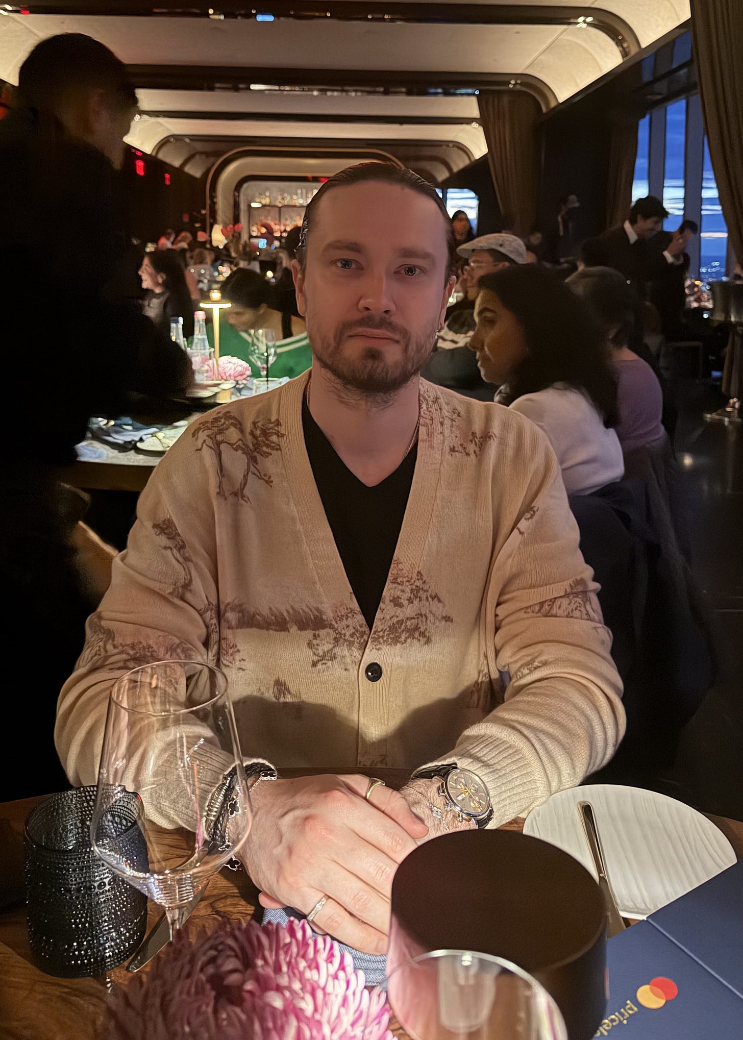 The founder sitting at a table in a restaurant, looking at the camera.