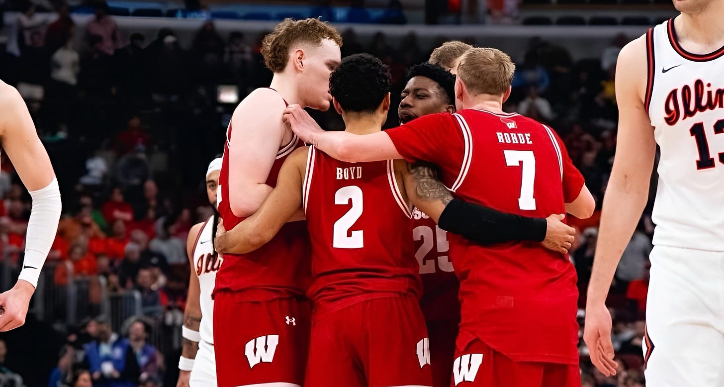 Wisconsin Badgers basketball players huddle during a game. Photo credit: UW Athletics. Wisconsin Badgers basketball players huddle during a game. Photo credit: UW Athletics.