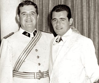 A couple of men in military uniforms

Description automatically generated