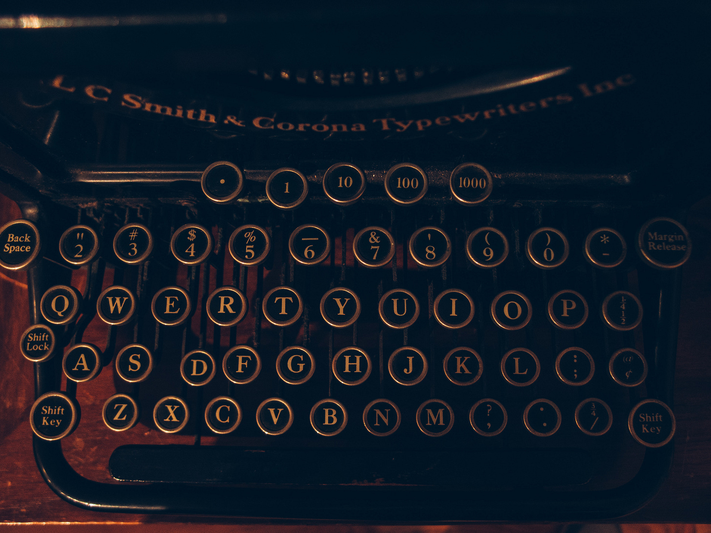 a dimly lit dramtic photo of an old typewriter keyboard