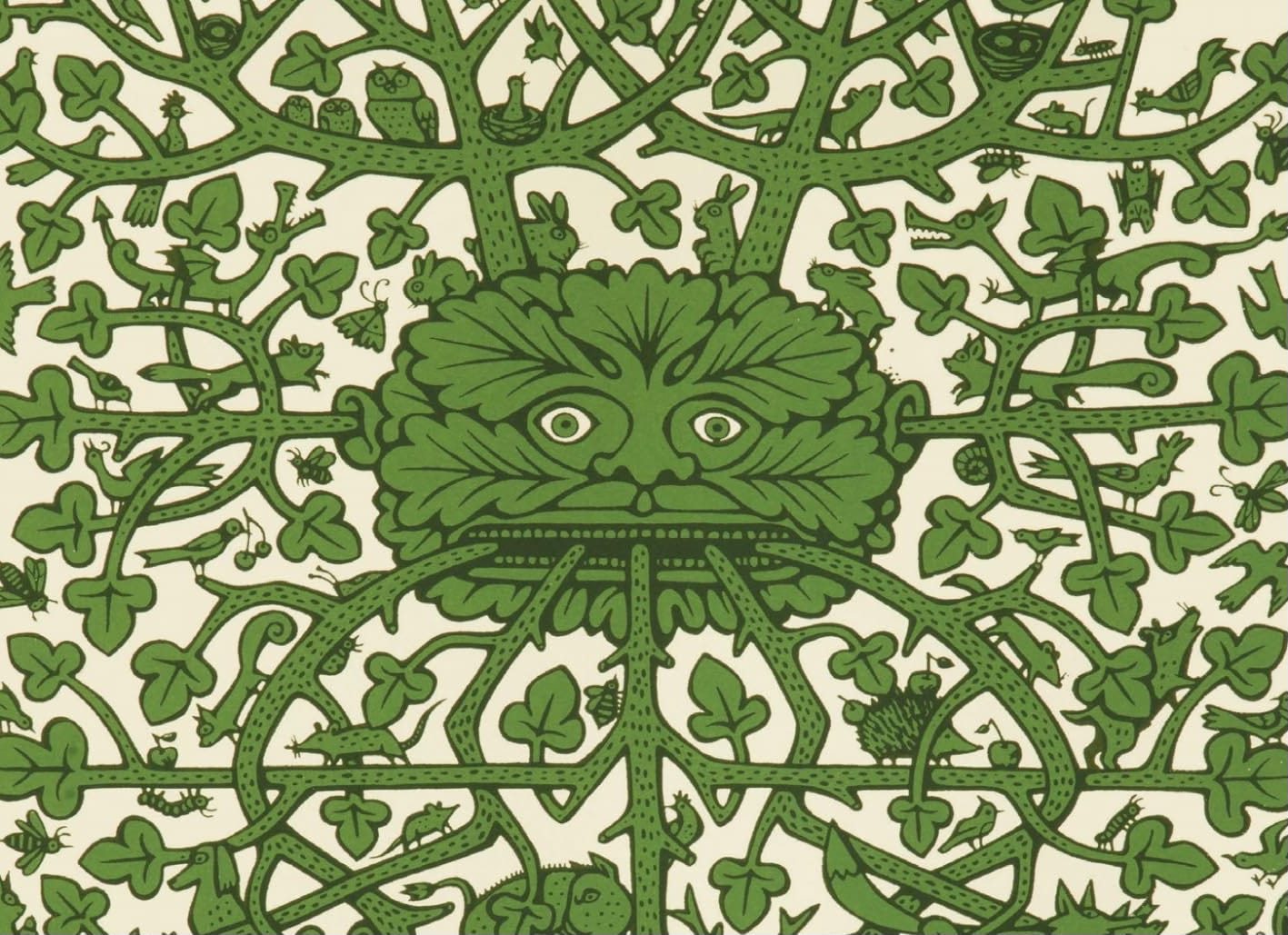 A Green Man face among an intricate mass of green branches and foliage incorporating small birds, animals and insects.