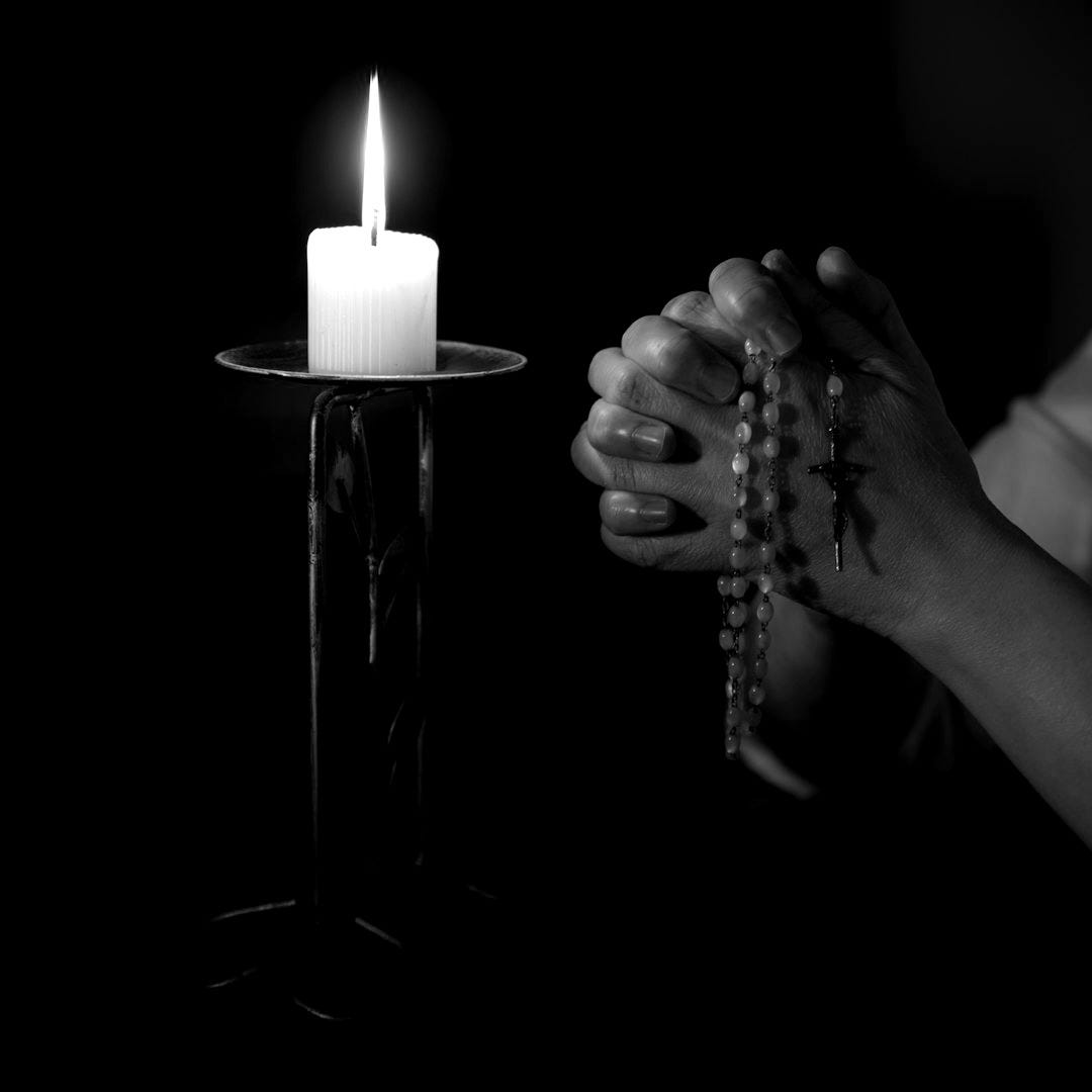 person holding white pillar candle