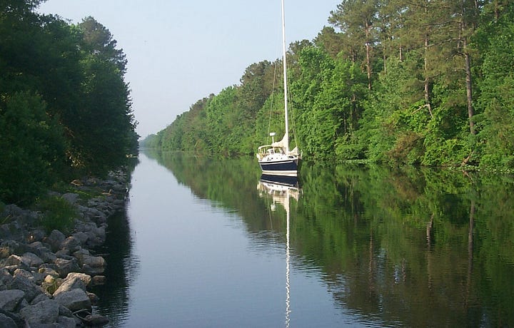 The Great Dismal Swamp historical marker and photo of the swamp canal by the U.S. Army Corps of Engineers, courtesy of Wikimedia Commons