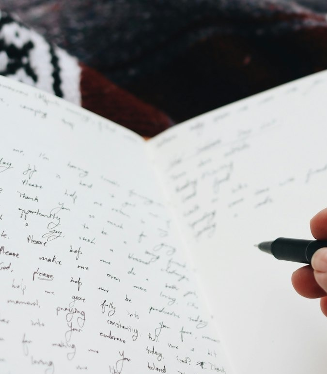 person writing on white paper