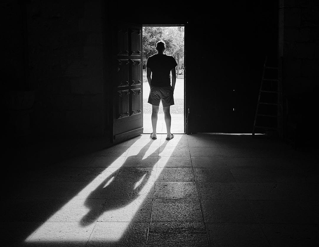 man standing beside door