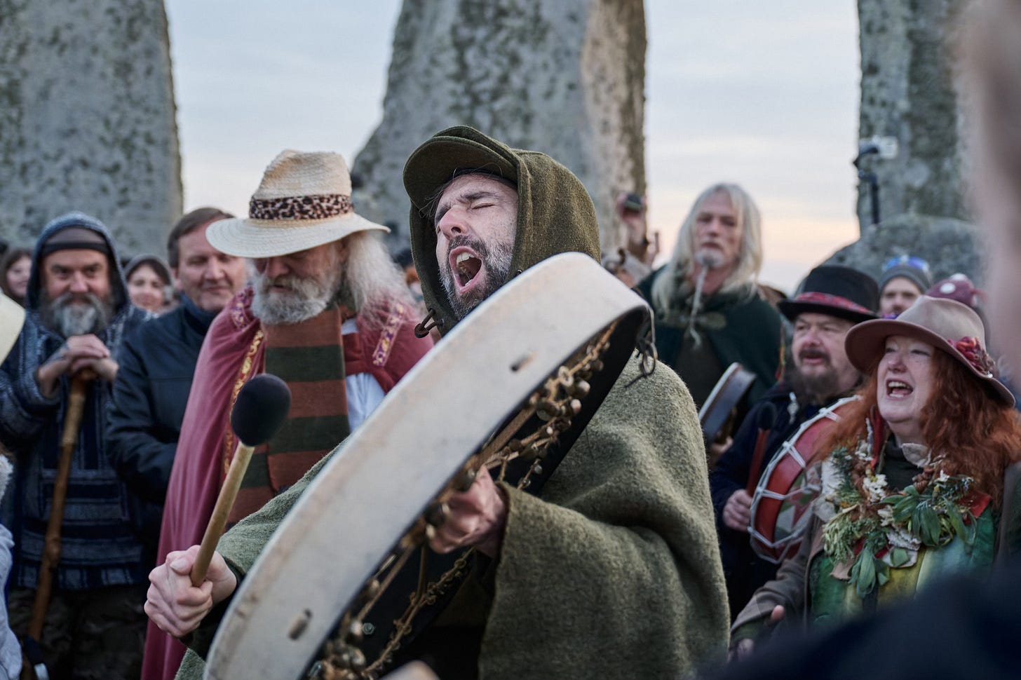 Documentary fieldwork photograph of a Druid Green Man in the Stonehenge Stone Circle, showing celebratory song at the Spring Equinox Documentary fieldwork photograph of a Druid Green Man in the Stonehenge Stone Circle, showing celebratory song at the Spring Equinox
