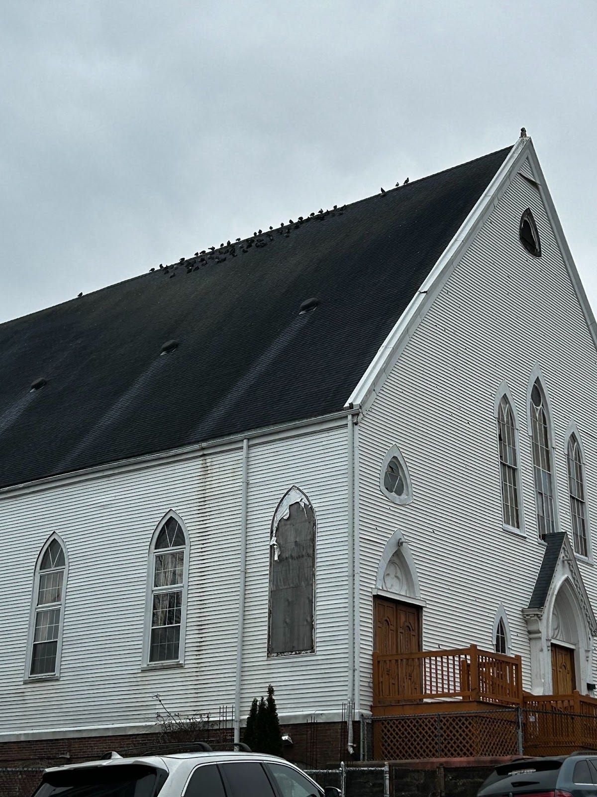 Birds sitting on top of the church on Mission Hill