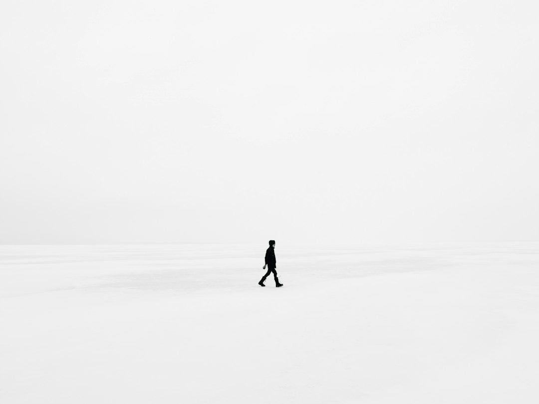 person walking on snowfield person walking on snowfield