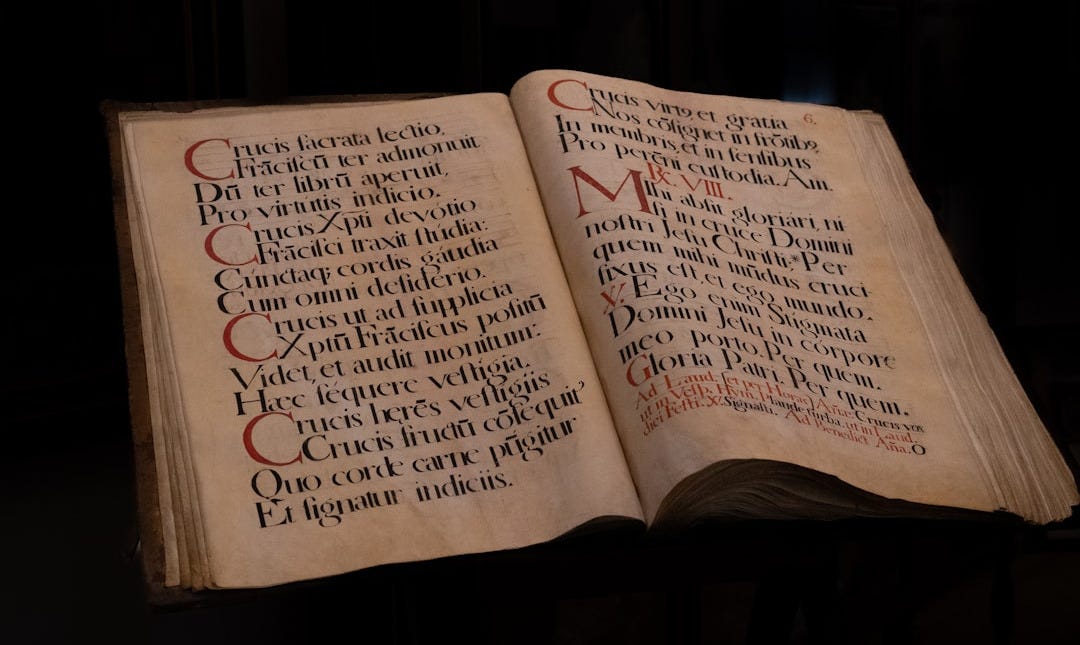 an open book with writing on it in a dark room