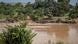 Groups of people on the banks of a muddy river Groups of people on the banks of a muddy river
