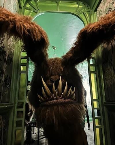 giant toothy bunny muppet creature coming down a narrow hallway giant toothy bunny muppet creature coming down a narrow hallway