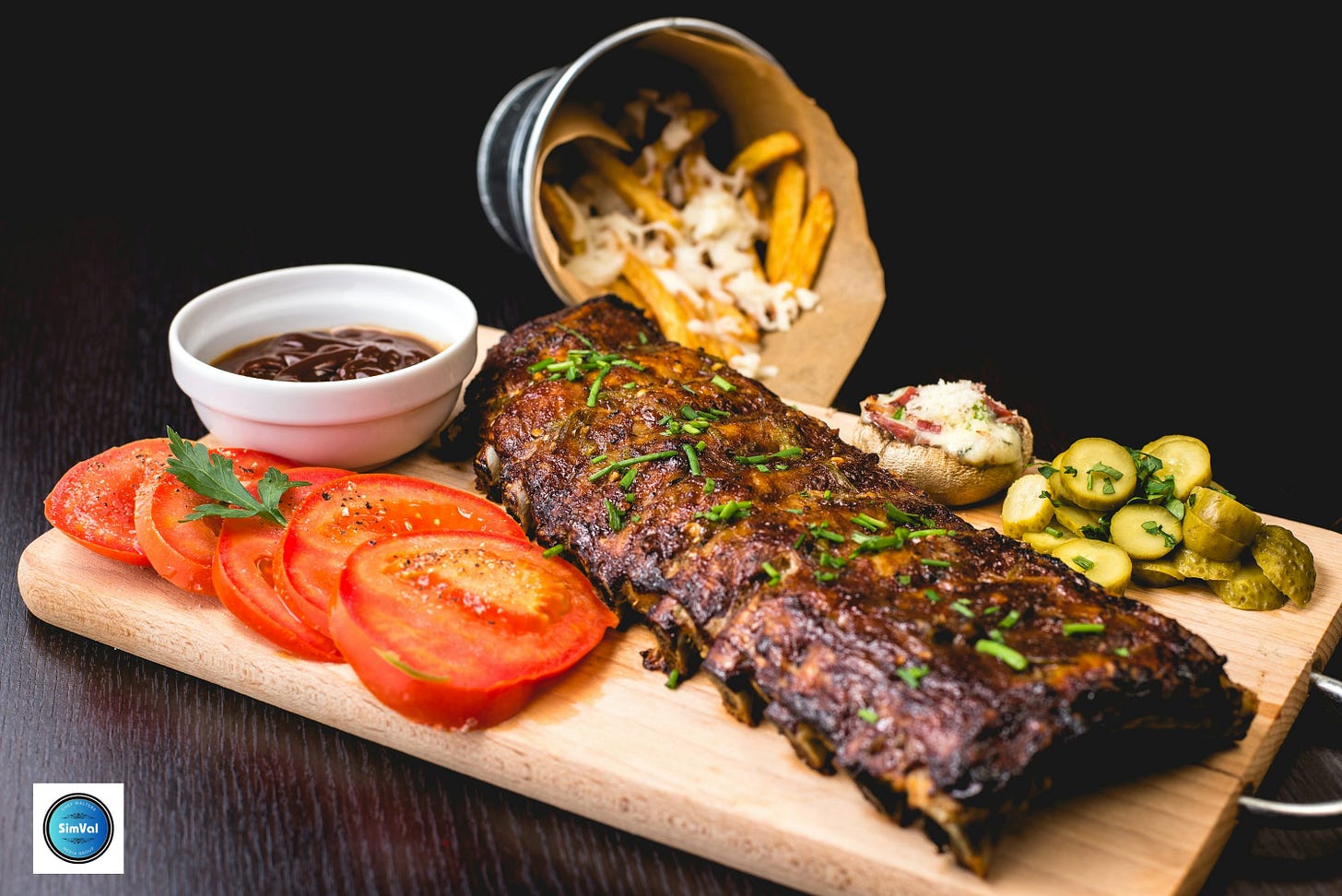 roasted ribs with sliced tomatoes and potatoes