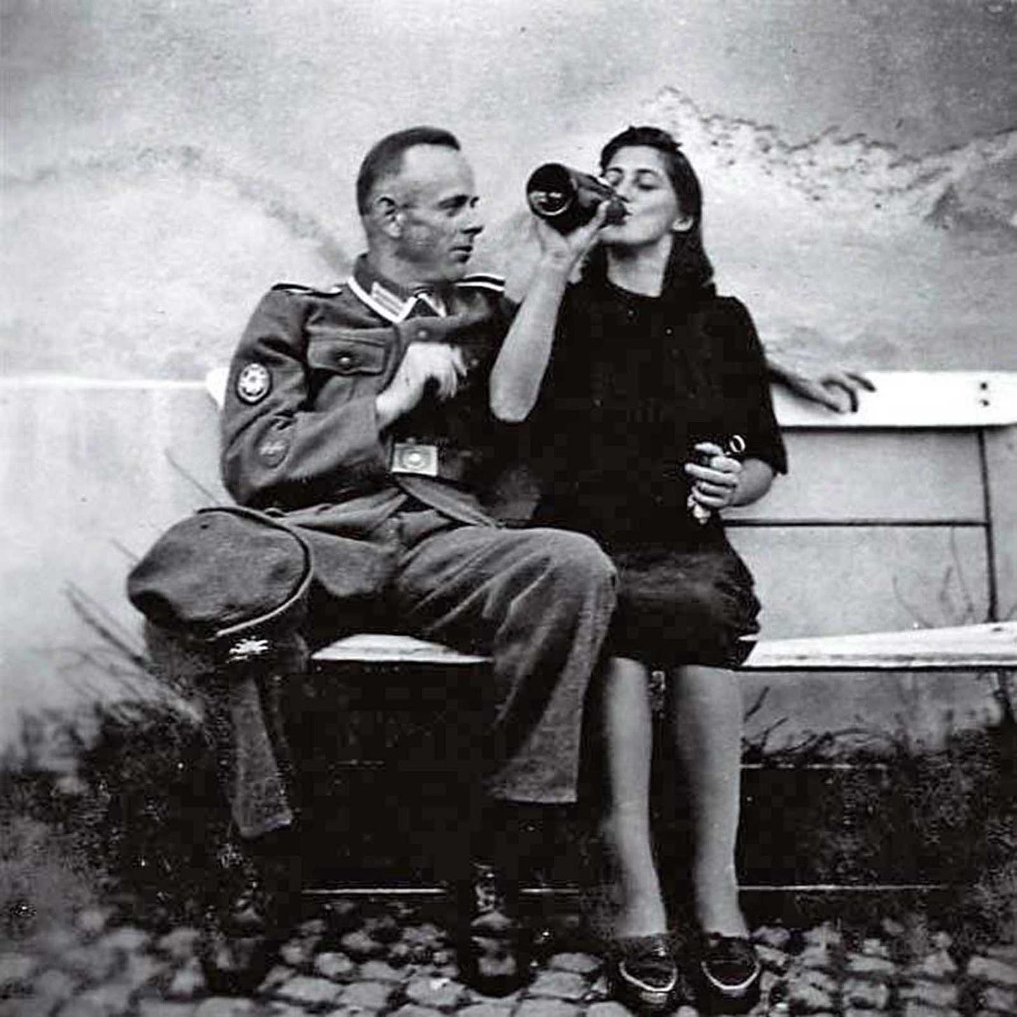 Despite his injury, a soldier enjoys a moment of leisure with a local woman, highlighting the complexities of personal relationships during wartime. Despite his injury, a soldier enjoys a moment of leisure with a local woman, highlighting the complexities of personal relationships during wartime.