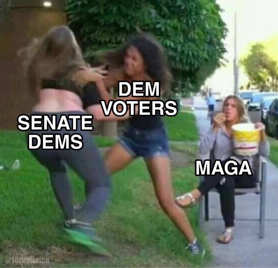 Two women in casual summer clothing one with brown hair wearing a gray top and denim shorts aggressively pushing from behind another woman with blonde hair in a gray top and beige pants who is falling forward arms outstretched towards a seated woman in a gray top and beige pants holding a bucket of popcorn on a park bench under green trees with a car parked nearby and green grass