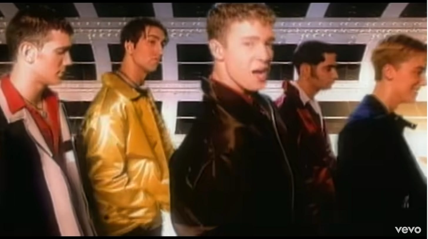 The guys are in a group; in this shot they're still, but in the video they're slowly walking in place down one of those space tunnels