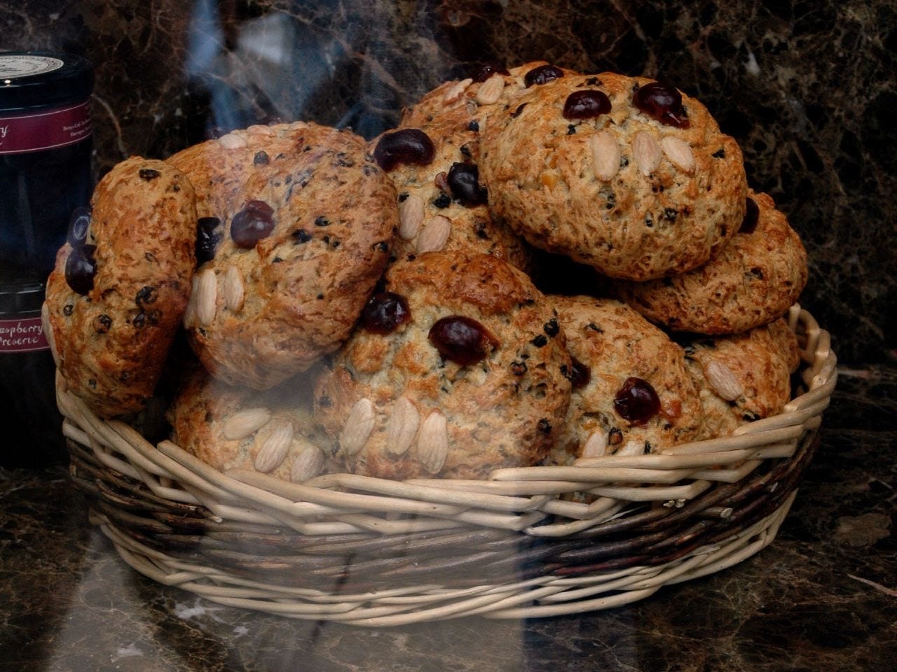 A basket of cookies on a marble counter

Description automatically generated