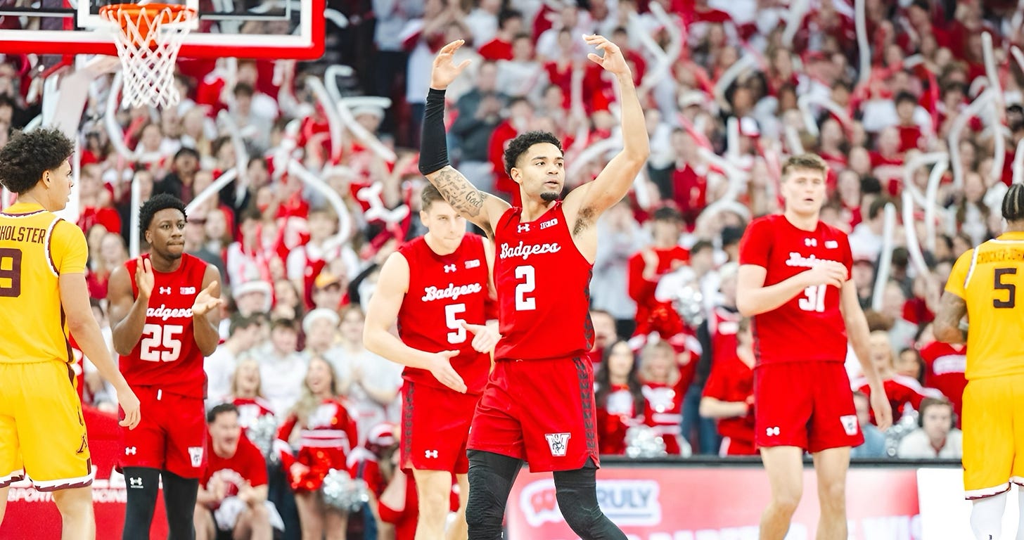 Wisconsin Badgers guard Nick Floyd pumps up the crowd at the Kohl Center with teammates standing behind him.