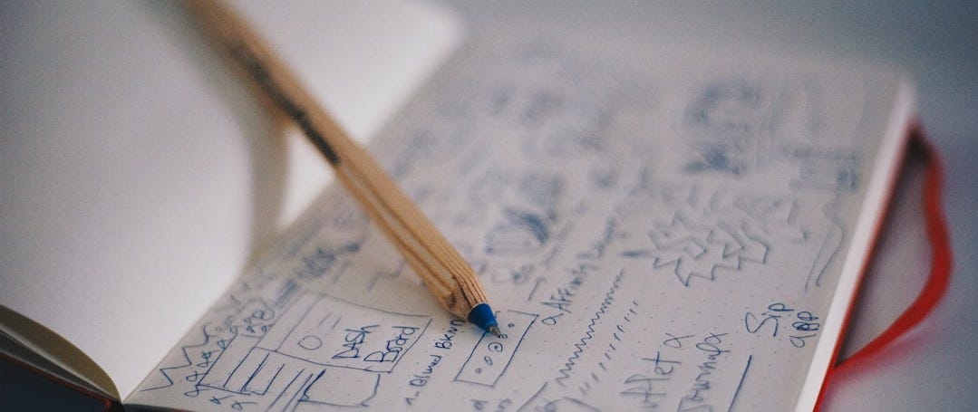 blue ballpoint pen on white notebook
