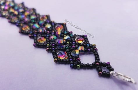 closeup photos of a beaded necklace made from black and rainbow/oil slick color shift beads