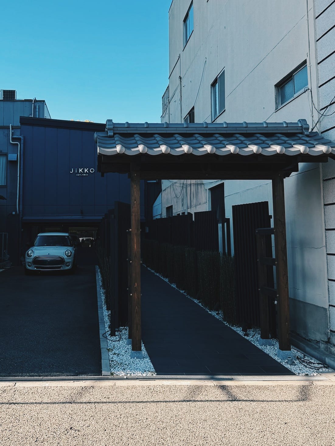 Traditional Japanese entrance gate with ceramic roof tiles at Jikko Cutlery workshop in Sakai, Osaka knife-making district