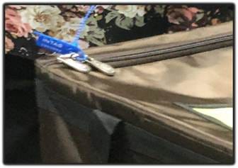 A close-up of a zipper on a suitcase

AI-generated content may be incorrect.