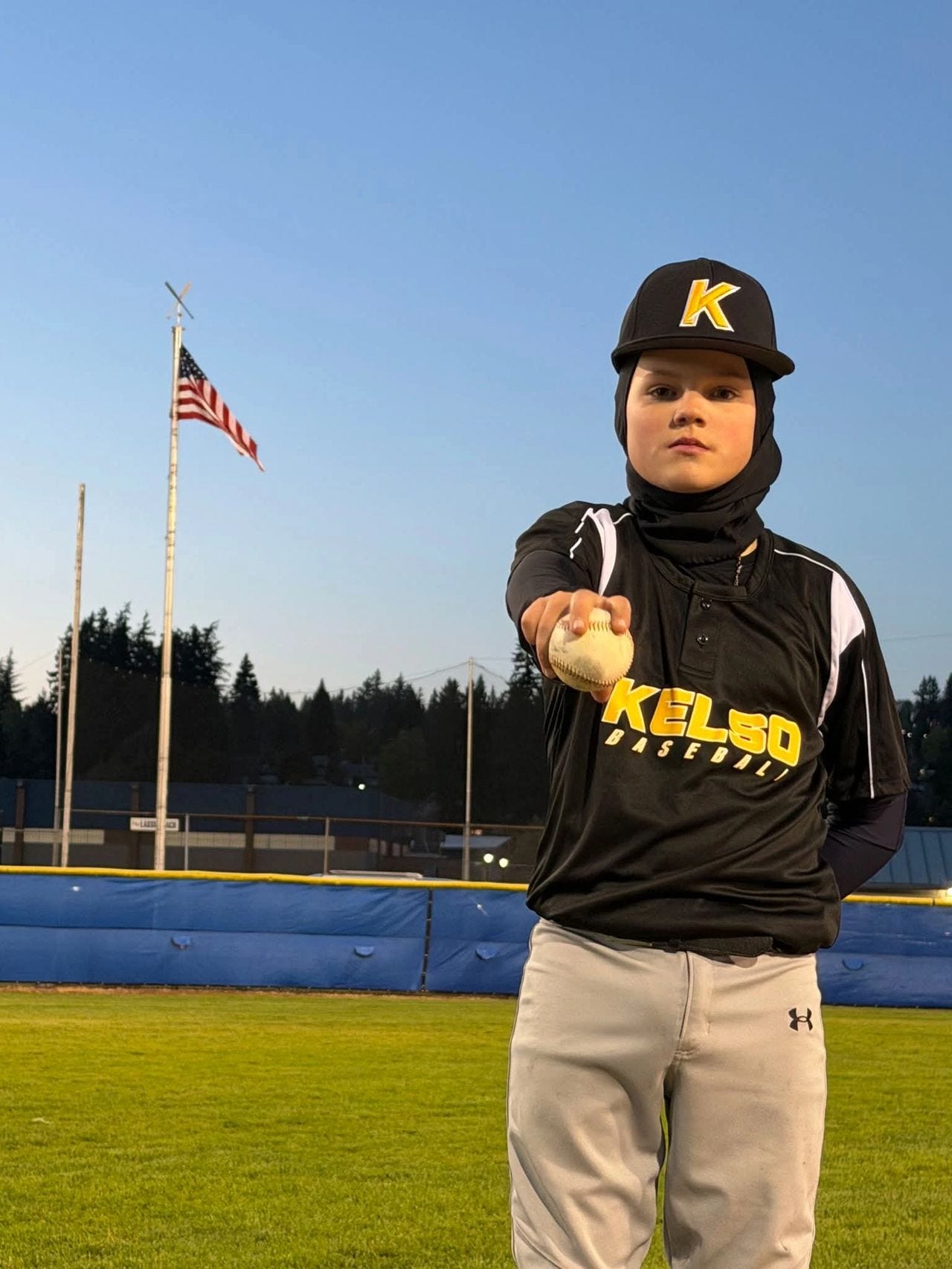 Jax Sorensen poses with the baseball he sent over the fence vs Bob's Sporting Goods