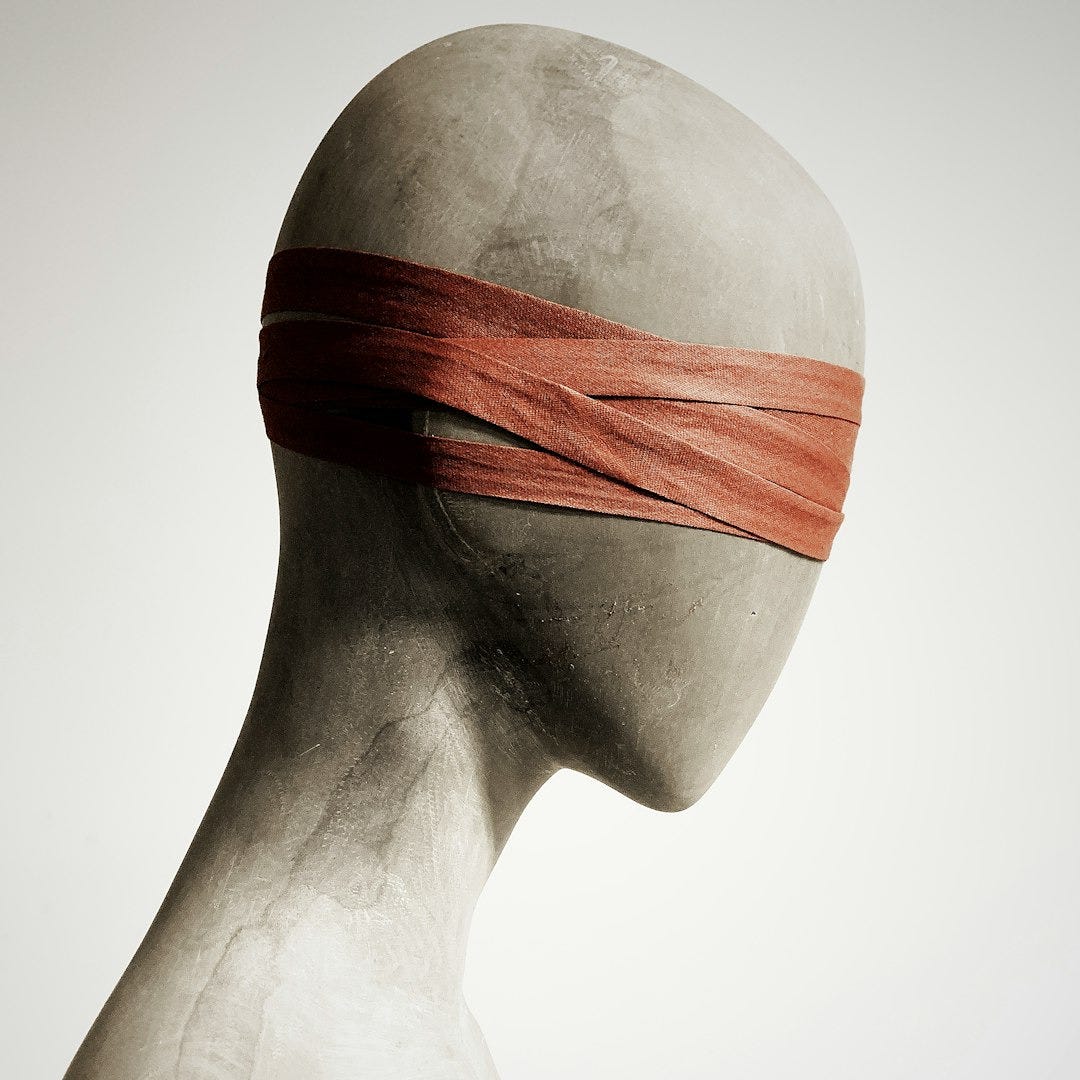 a white mannequin with a red band on its head a white mannequin with a red band on its head