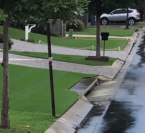 Photo of extremely near grass with little fences to stop people walking there