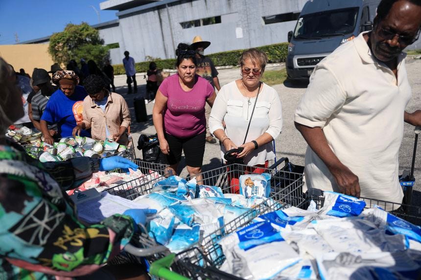People receive groceries from the Curley's House Food Bank in Miami in late October. Millions of Americans may see their food stamp benefits for November delayed or skipped.