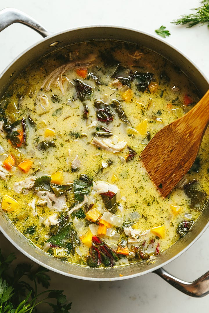 Charred lemon and dill chicken soup in a pot and in a bowl.