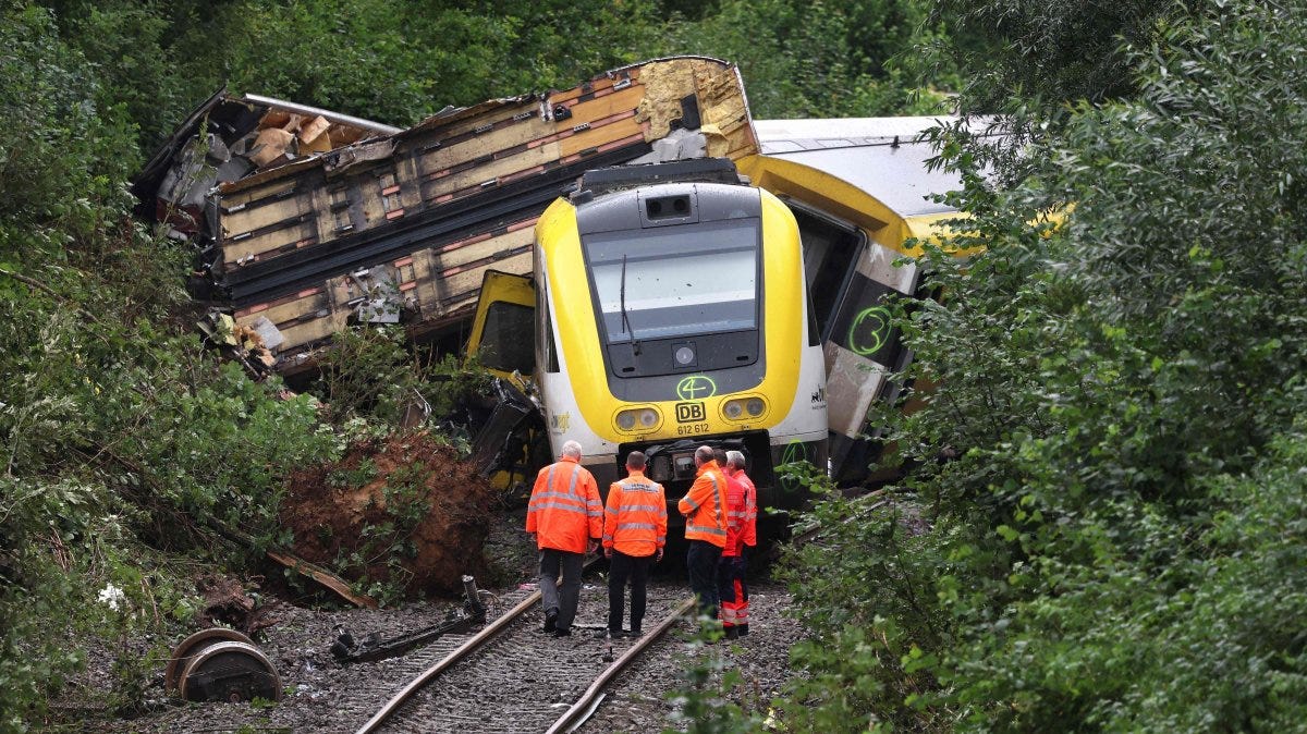 Employees of German rail operator Deutsche Bahn AG stand in front of a derailed train near Riedlingen, southwestern Germany, July 28, 2025. (AFP Photo)