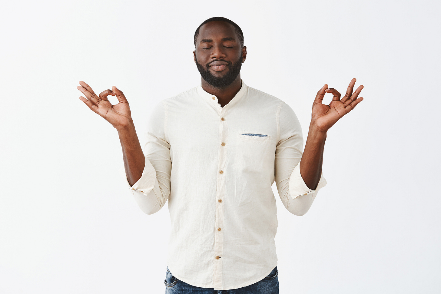 Patient and relaxed young guy posing against white wall