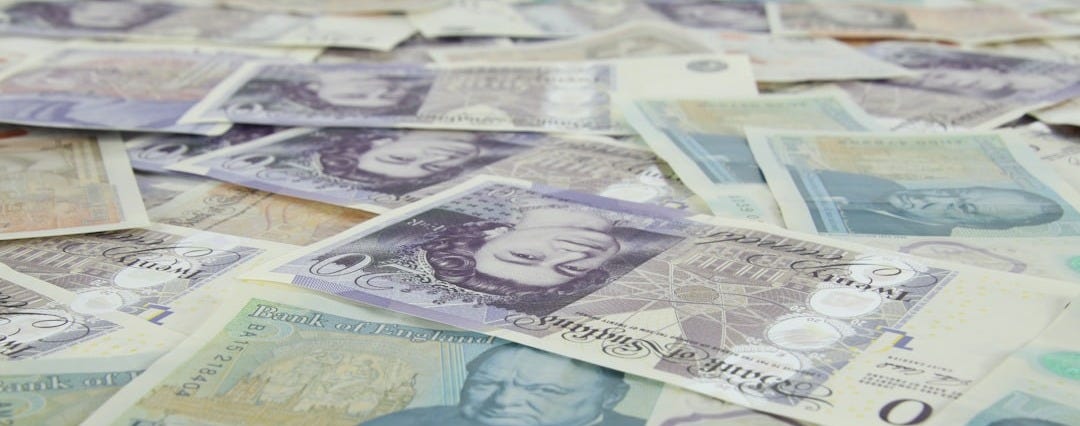 5 pieces of banknotes on yellow and white textile