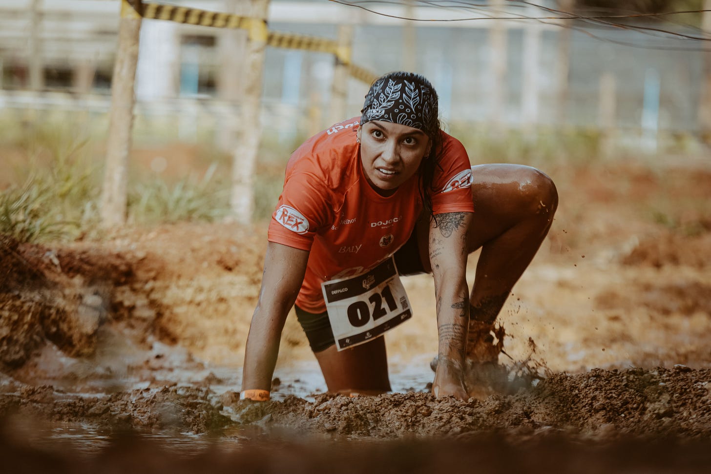 Image of a woman doing the 'Tough Mudder' event and using her whole body with strength and stability Image of a woman doing the 'Tough Mudder' event and using her whole body with strength and stability