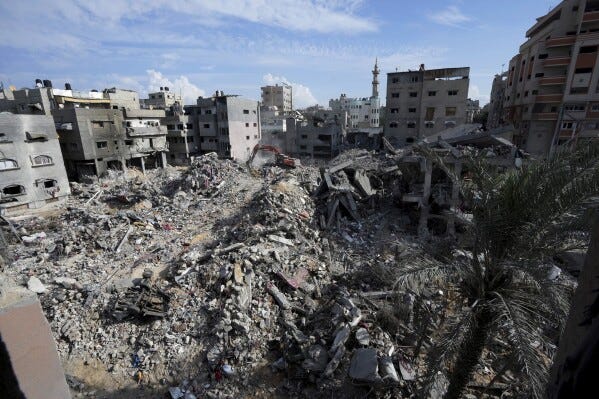 Israel-Hamas war: Families dig by hand to retrieve bodies buried in Gaza  rubble | AP News
