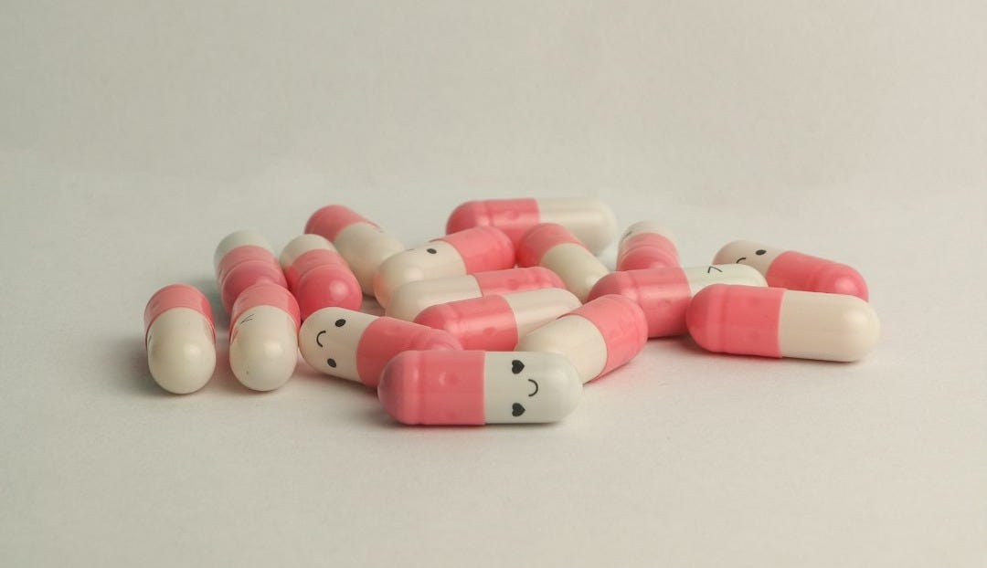 pink and white medication pill
